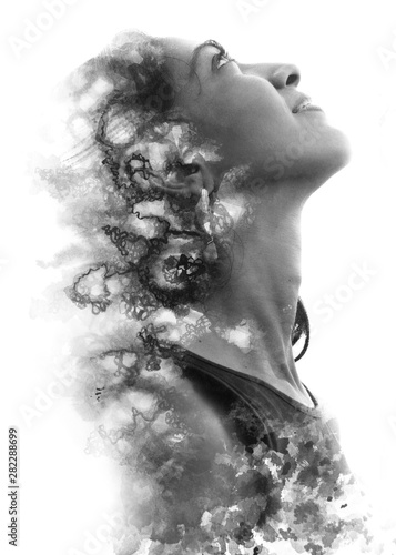 Paintography. Double Exposure portrait of a beautiful ethnic woman's profile combined with hand drawn watercolor painting. black and white