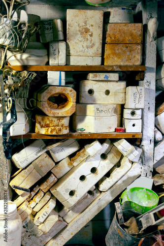 Clay studio shelves filled with ceramic molds.