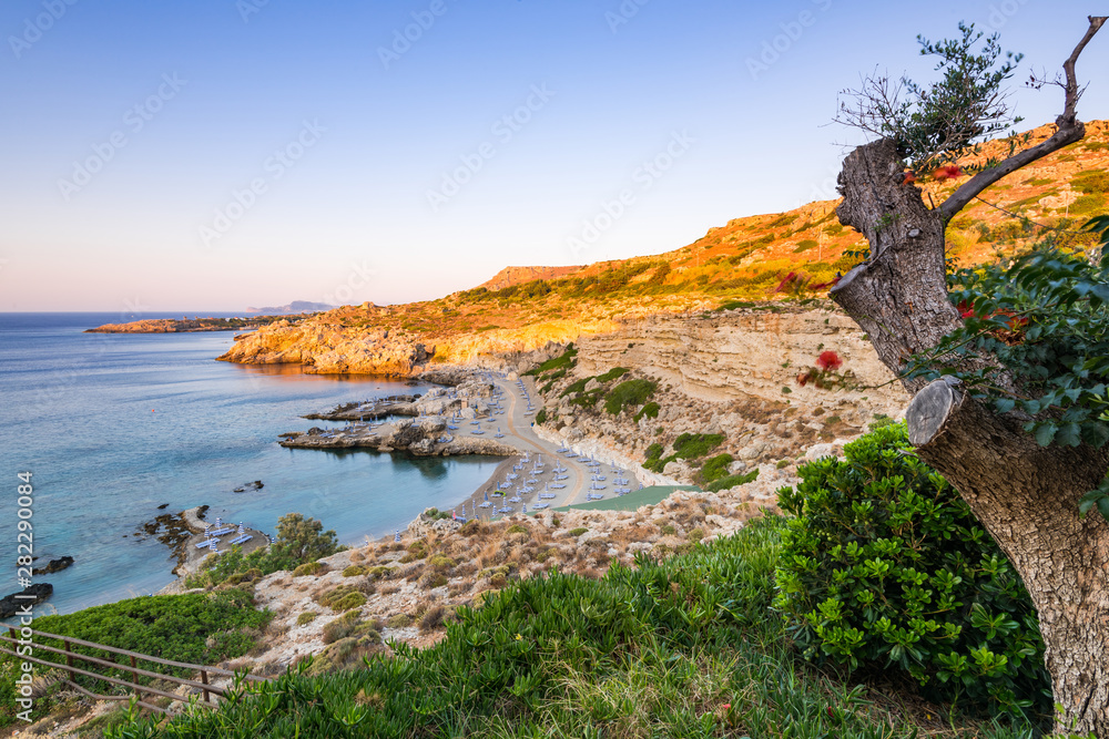 Beautiful Sunrise over Pebble Beach and Cliffs at Rhodes Island, Greece