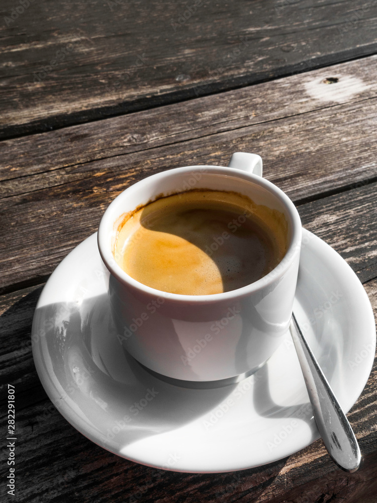 cup of coffe, image shape from shadow Yin Yang, on wooden background. White ceramic cup, stylish toning, copy space cup of coffe, image shape from shadow Yin Yang, on wooden background. White ceramic cup, stylish toning, copy space