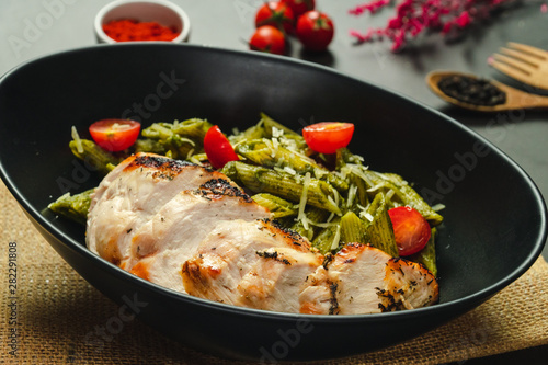 Food shot pesto pasta with grilled chicken breast