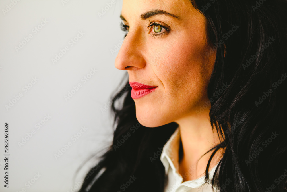 Portrait of mature brunette woman, with beautiful eyes, in casual pose and white background. Portrait of mature brunette woman, with beautiful eyes, in casual pose and white background.