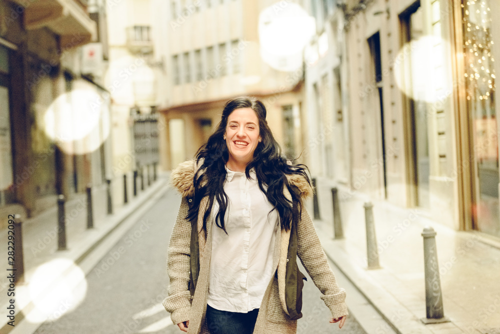 Mature woman happy and confident of herself walking through the streets of a European city.