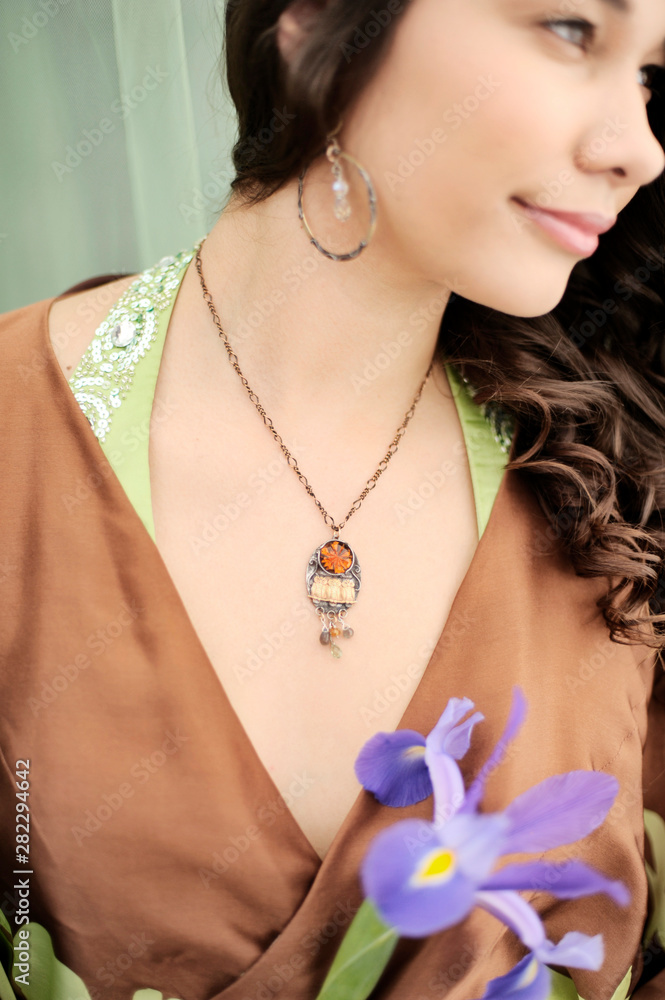 Woman wearing owl necklace with asian spring time fashion.