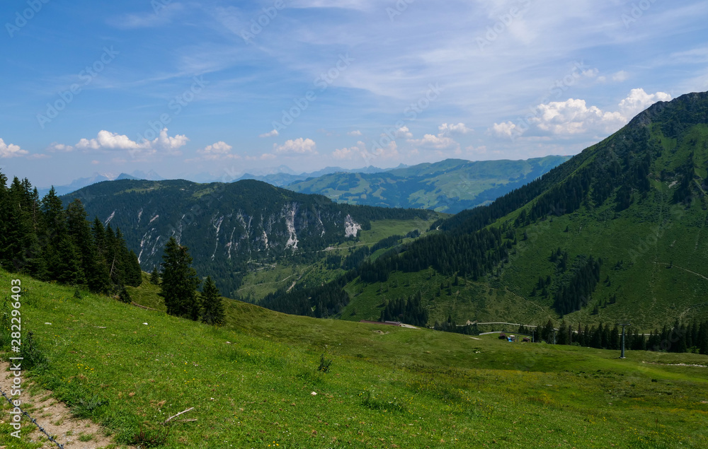 Beautiful alpine landscape with green meadows, alpine cottages and mountain peaks, Alpinolino, Westendorf Tyrol Alps, Austria