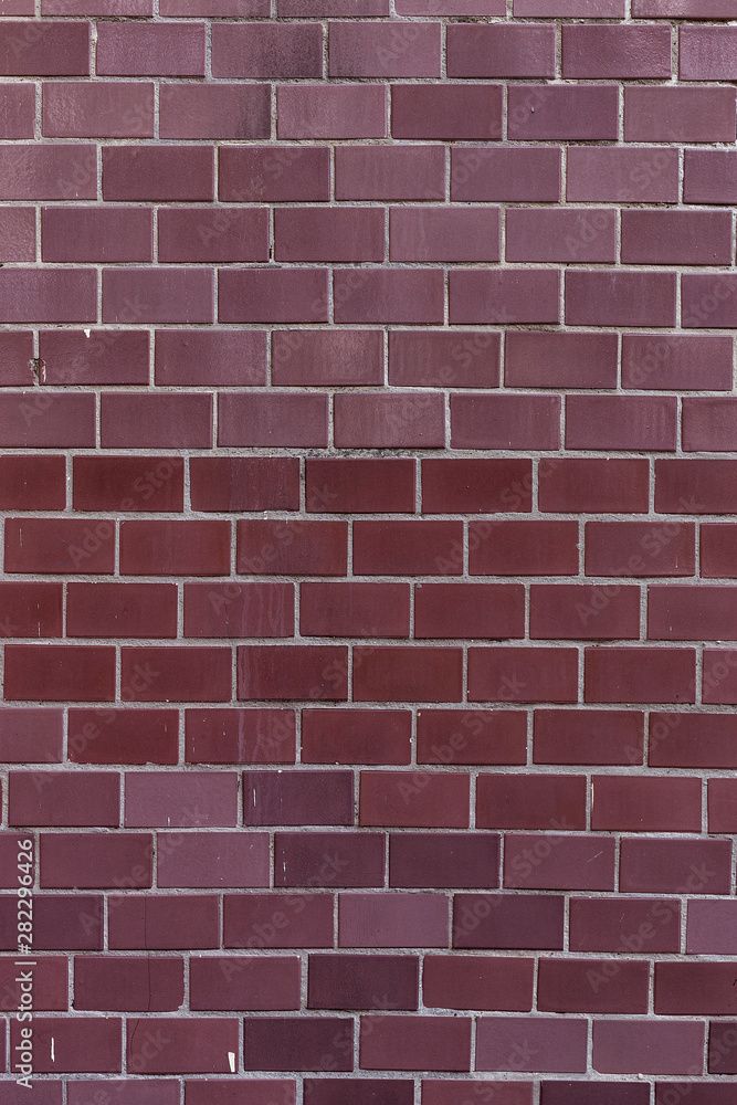 Fototapeta premium Old burgundy tile on the wall, rustic background.