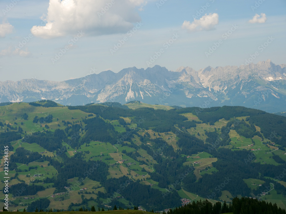 Beautiful alpine landscape with green meadows, alpine cottages and mountain peaks, Alpinolino, Westendorf Tyrol Alps, Austria