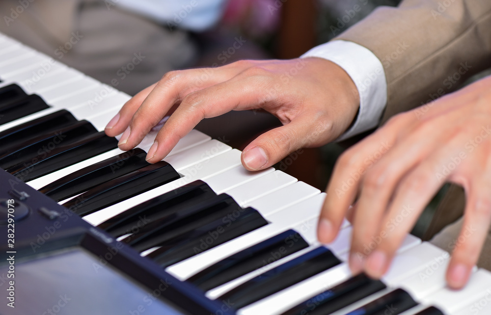 Close up man hand playing piano on wedding or concert Close up man hand playing piano on wedding or concert
