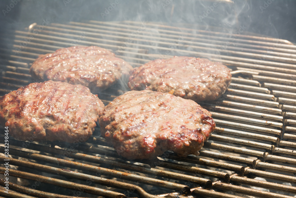 Close Up of Beef Hamburger Cooking on a Charcoal Grill