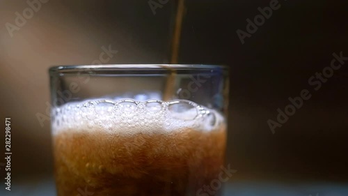 Wallpaper Mural Coke is poured into a glass. fizzy drink over brown background. Food background. Torontodigital.ca