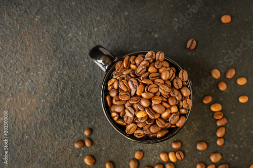 coffee beans (roasted coffee beans) Arabica and Robusta blend. Dark background. Top view . Copy space