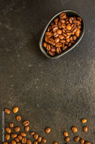 coffee beans (roasted coffee beans) Arabica and Robusta blend. Dark background. Top view . Copy space