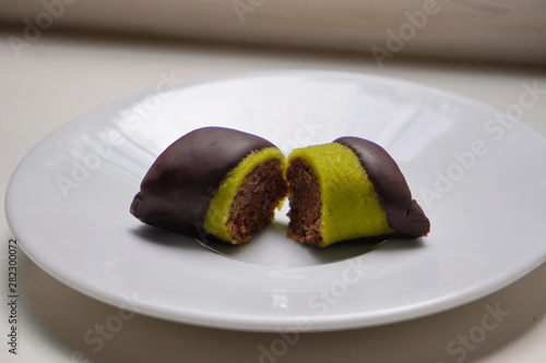 candy  pistachio in chocolate lying on white plate  healthy sweets