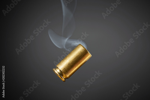 smoking bullet casing tumbling photo