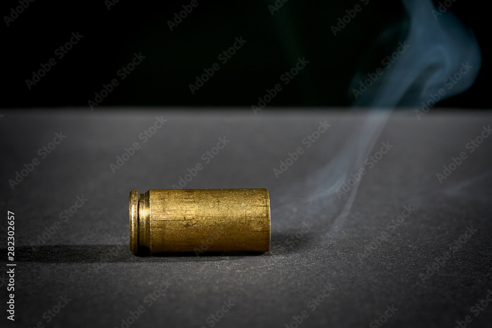 smoking bullet casing dropped on the ground smoking bullet casing dropped on the ground