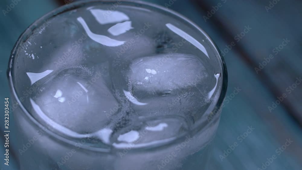 Close-up Top view of a glass of cold cola with ice cubes. Food background. Close-up Top view of a glass of cold cola with ice cubes. Food background.