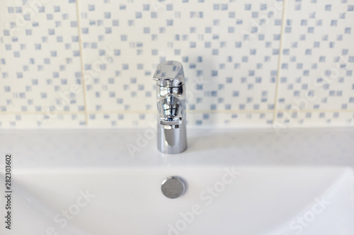 Bathroom interior with sink and faucet.