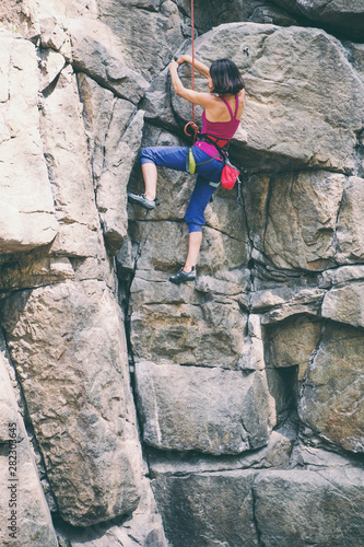 Rock climber is training on natural terrain.