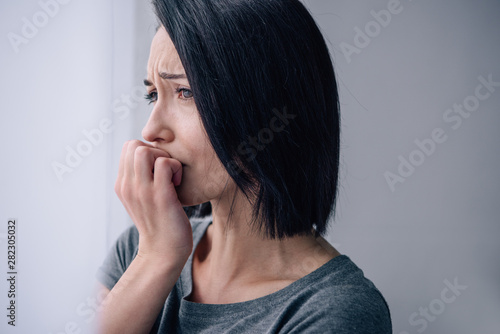 beautiful upset woman covering mouth at home