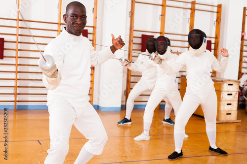 Sporty african american man fencer practicing effective fencing techniques