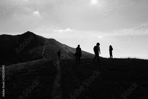idyllic landscape at Monte Tamaro in Switzerland - silhouette of people © kingmauri