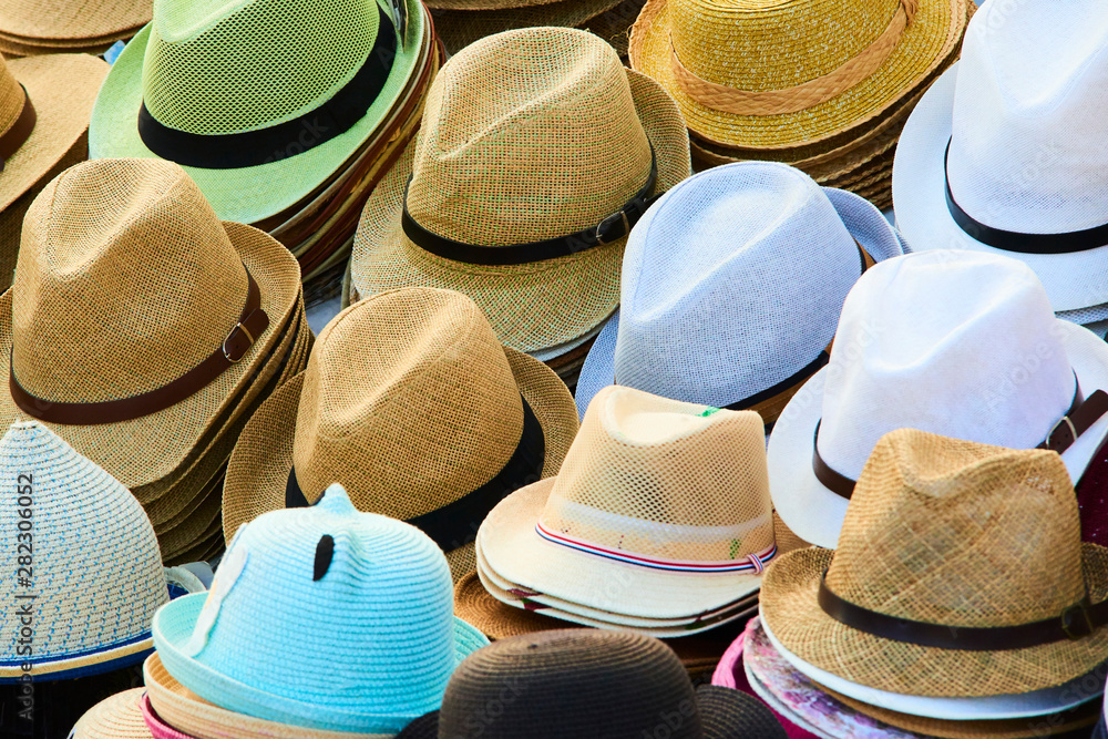 Various hats for sale from a sidewalk vendor