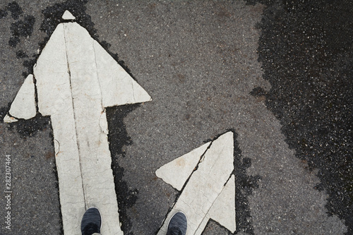 Vászonkép People standing at the crossroad and get to decision which way to go with copy space for insert text