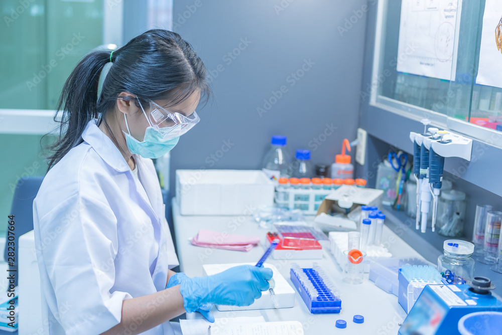 The scientists injected chemicals into plastic tubes,Scientist mix chemicals with The shake machine Before the experiment.Mixture laced with samples into test tubes,prepare sample for test The scientists injected chemicals into plastic tubes,Scientist mix chemicals with The shake machine Before the experiment.Mixture laced with samples into test tubes,prepare sample for test
