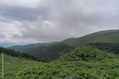 Mountain range in a fog in Bieszczady, Poland. © cronislaw