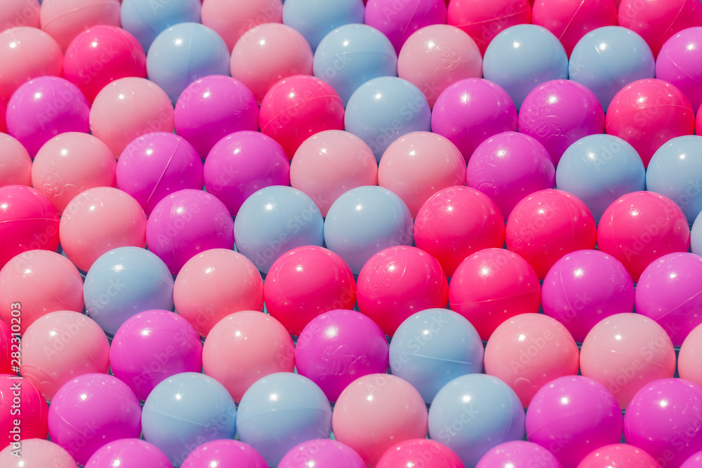 Isolated view on plastic balls. Concept for order, diversity, fun, happiness, perfection, alignment, being different, joy. Colorful background, row pattern, round, diagonal.