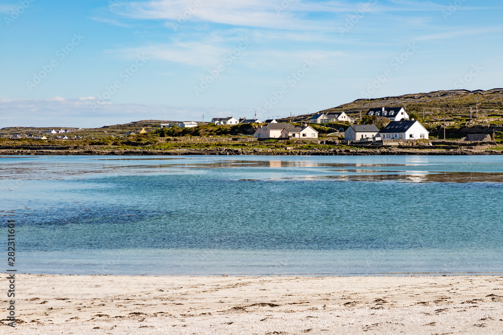 Ocean, reflection and houses in Inishmore