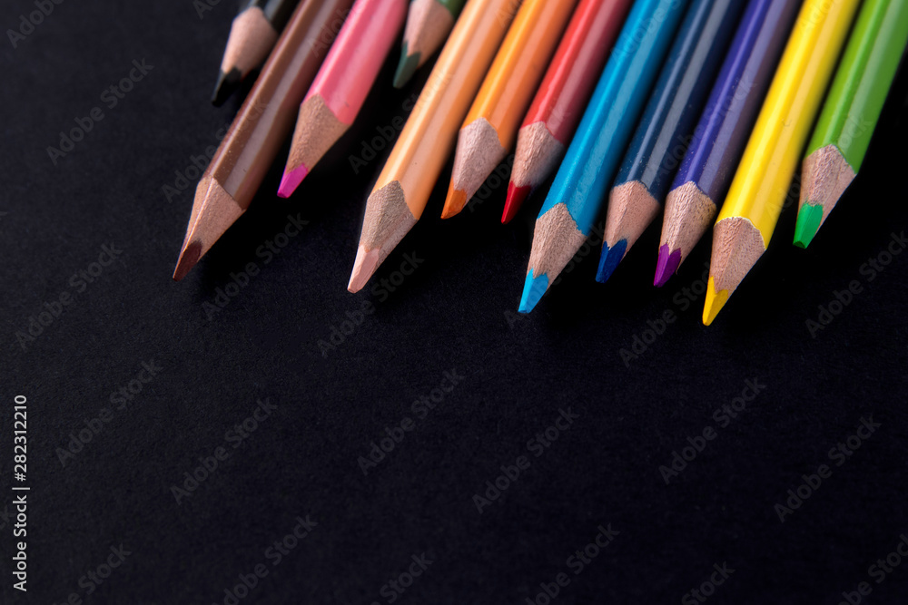 Color pencils with copy space isolated on black background,education frame concept Color pencils with copy space isolated on black background,education frame concept