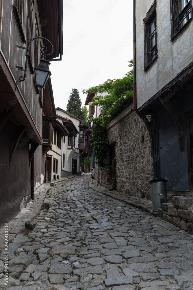  View of a narrow street in  historical part of  Plovdiv Old Town. Typical medieval colorful buildings. Bulgaria