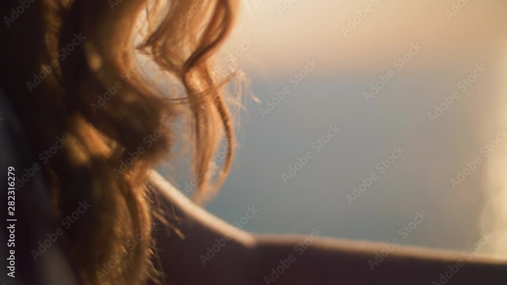 Woman hair blowing in the breeze from behind. SLOW MOTION Woman hair blowing in the breeze from behind. SLOW MOTION
