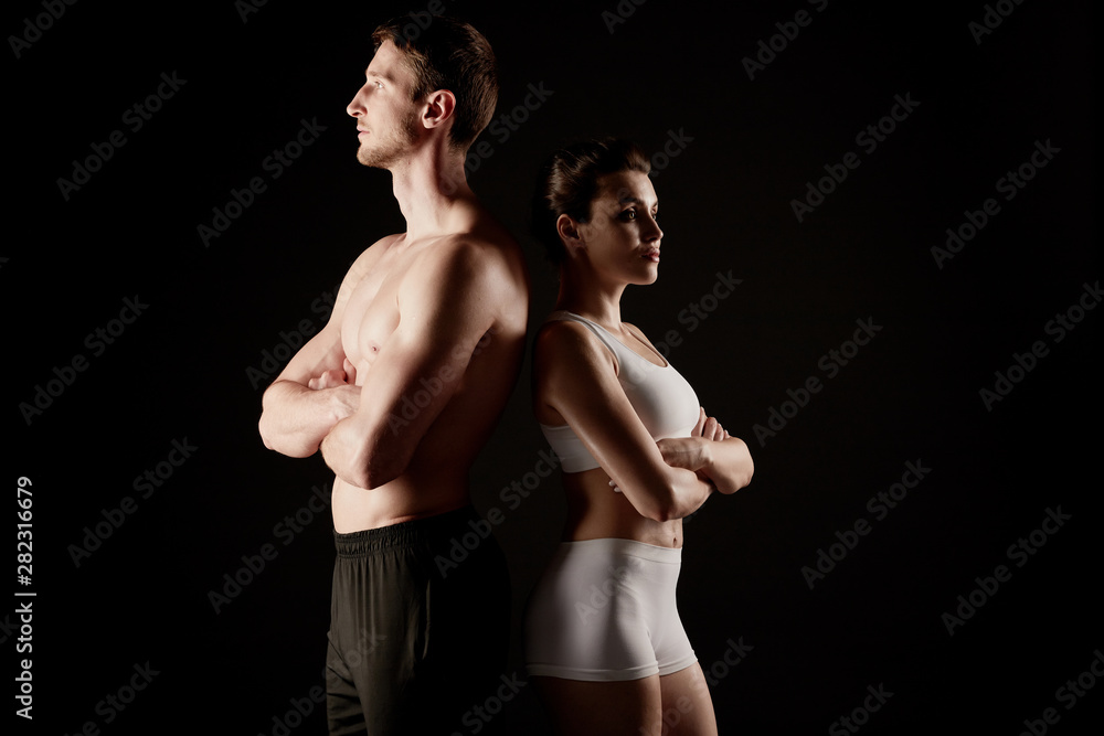 Fit couple in sportswear poses at the camera.