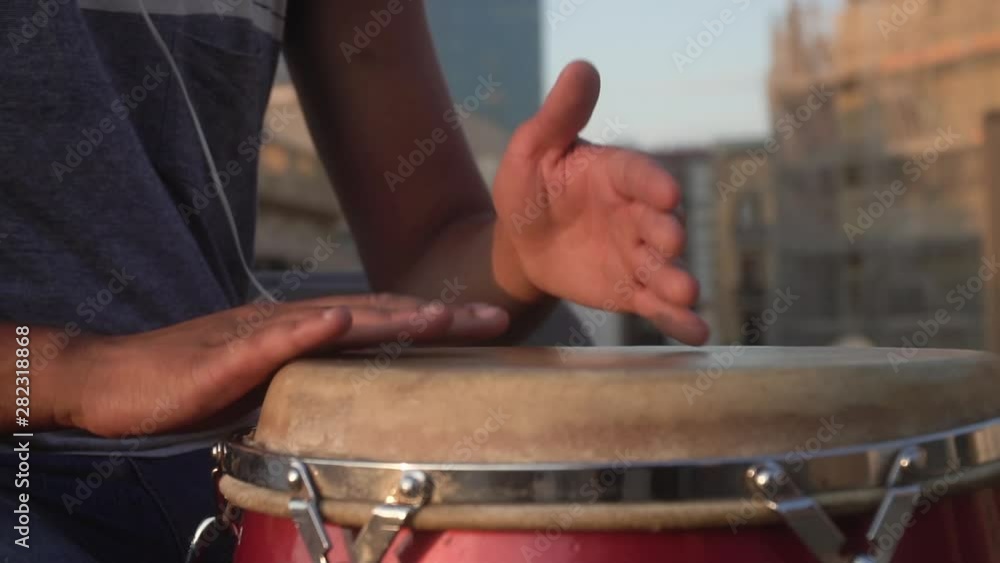 closeup of hands playing drums with a bongo closeup of hands playing drums with a bongo