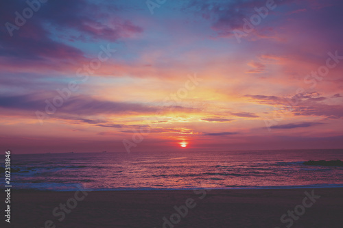 Sunset over the ocean. Sandy beach at sunset. Beautiful seashore in the evening.  Porto  Portugal  Europe