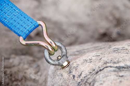 Bolt fastening slings rock climbing into stone photo