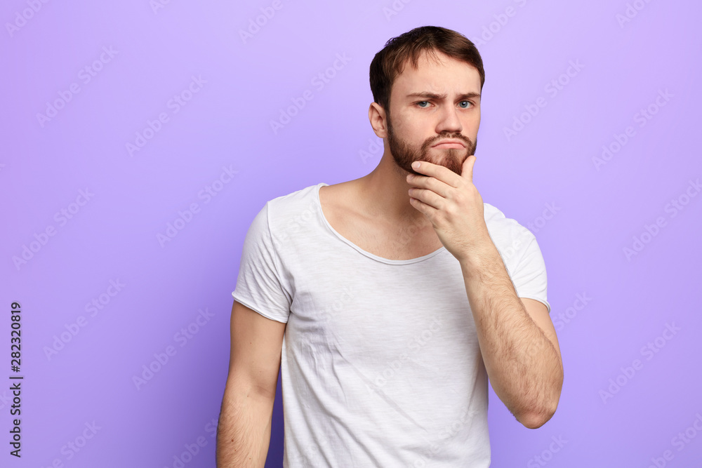 young puzzled man thinking about problem, trying to solve it, making a decision, close up portrait young puzzled man thinking about problem, trying to solve it, making a decision, close up portrait