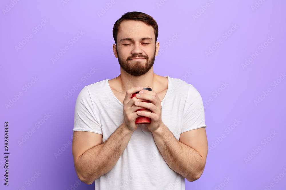 happy handsome man with closed eyes holding hot morning coffee. guy enjoying drinking takeaway coffee. time for coffee break, free time, spare time, lifestyle happy handsome man with closed eyes holding hot morning coffee. guy enjoying drinking takeaway coffee. time for coffee break, free time, spare time, lifestyle