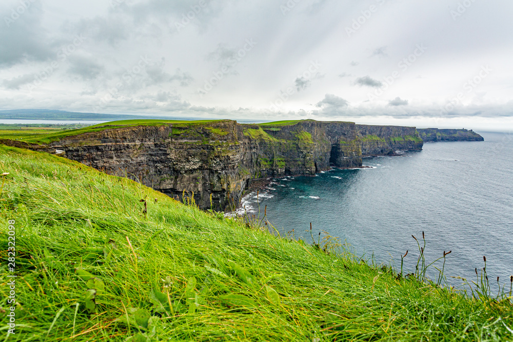 Spectacular view of the Cliffs of Moher, geosites and geopark, Wild Atlantic Way, wonderful cloudy spring day in the countryside in county Clare in Ireland