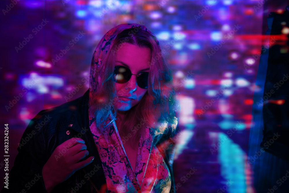 young woman wearing metal jacket in neon lights young woman wearing metal jacket in neon lights