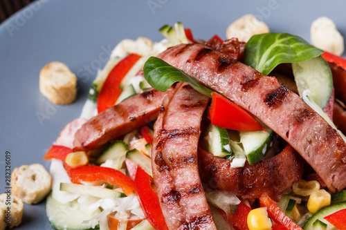 Salad with grilled sausage paprica cucumber and croutons