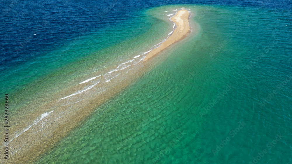 Aerial drone photo of tropical exotic island sand bar separating sea in two with turquoise and sapphire breathtaking colours Aerial drone photo of tropical exotic island sand bar separating sea in two with turquoise and sapphire breathtaking colours