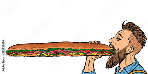 man eats a long sandwich