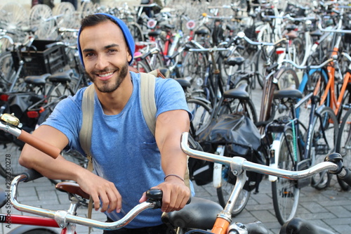 Photography Handsome ethnic man in bicycle parking lot