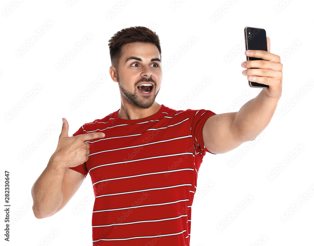 Excited young man taking selfie on white background Excited young man taking selfie on white background