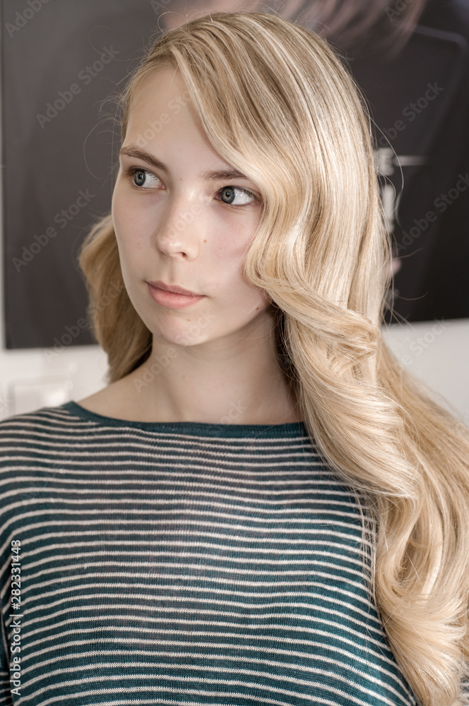 Fototapeta premium Blonde girl with long hair with wave hairstyle