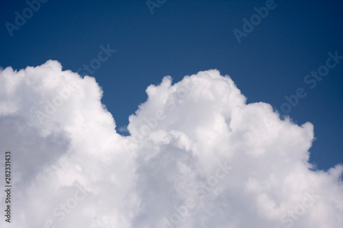 Thick white cloud on blue sky background.