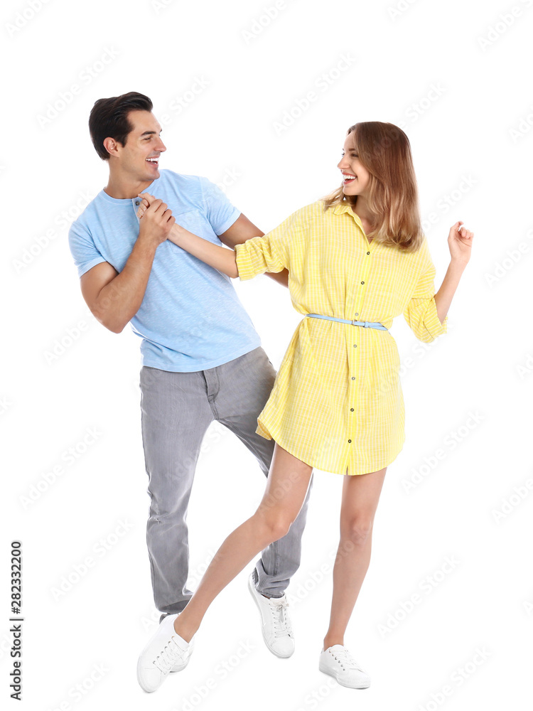 Beautiful young couple dancing on white background